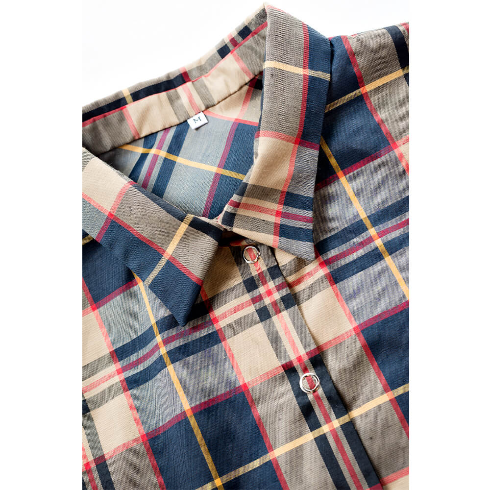 Detalle del botón metálico de presión y textura impermeable de la camisa de cuadros seleccionada por Remolona.